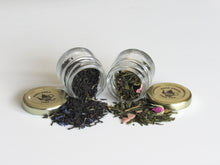 Two glass jars with tea leaves and loose tea by Lulu Island Honey